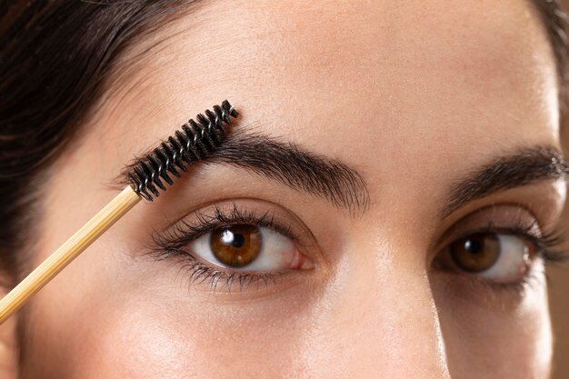 Woman taking care of her eyebrows