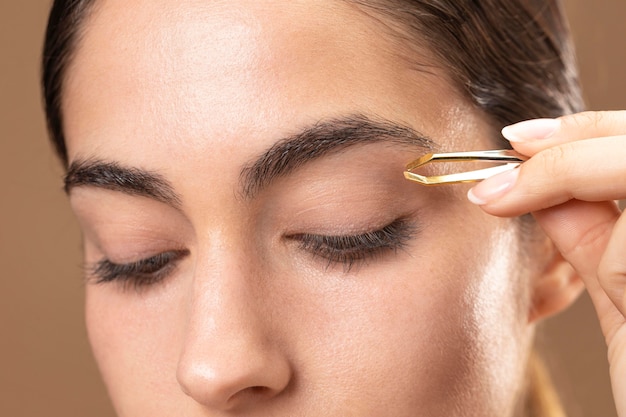 Woman taking care of her eyebrows