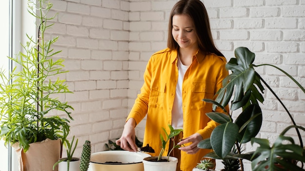 Woman taking care of her plants in her home garden