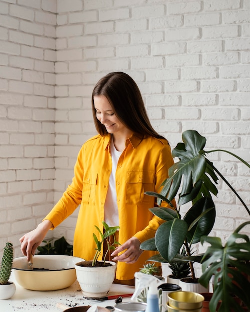 Woman taking care of her plants in her home garden