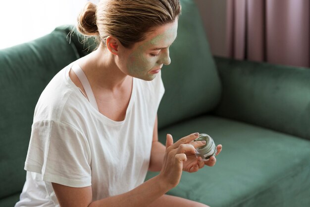 Woman taking care of herself with facial mask