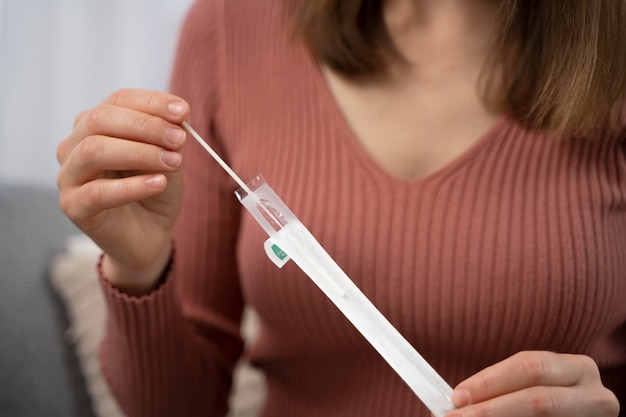 Woman taking a covid test alone at home