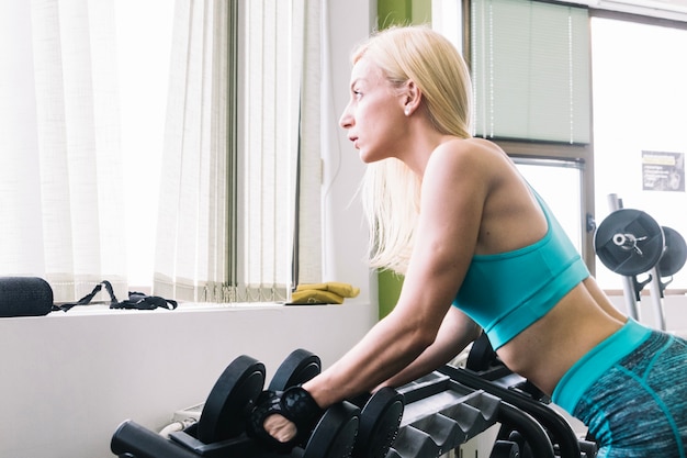 Free photo woman taking dumbbells