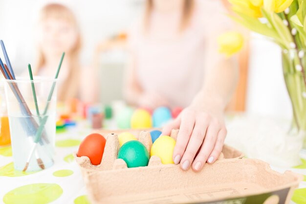 Woman taking Easter egg from box