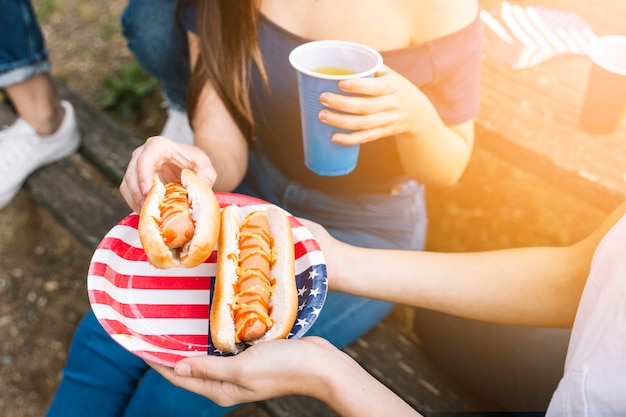 Free photo woman taking hot-dog