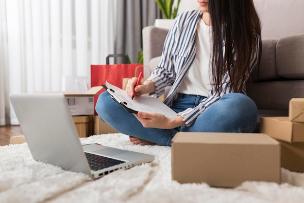 Woman taking notes about cyber monday purchases