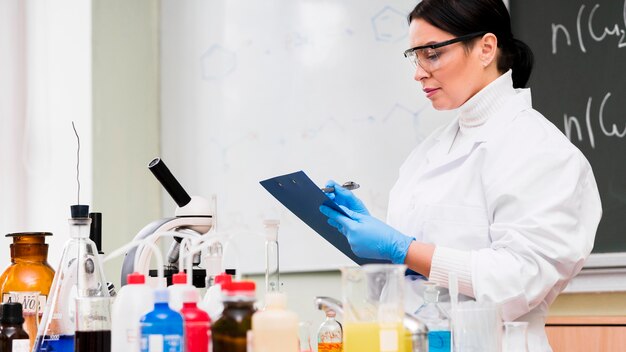 Woman taking notes in laboratory