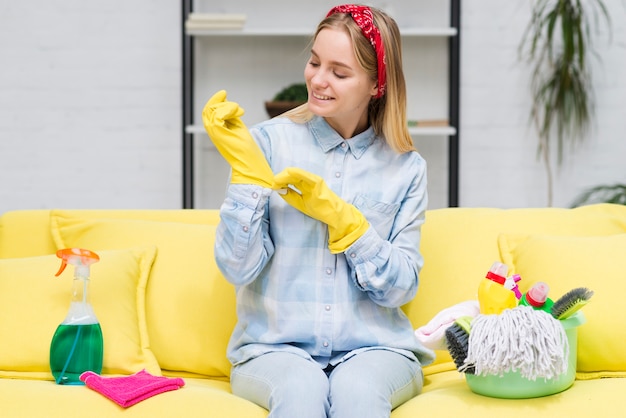 Woman taking off cleaning gloves