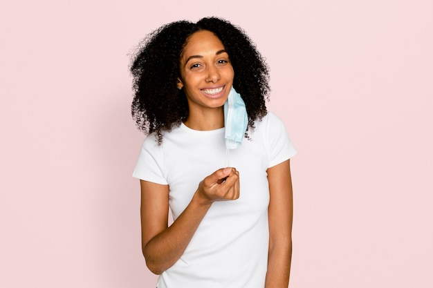 Woman taking off mask in the new normal