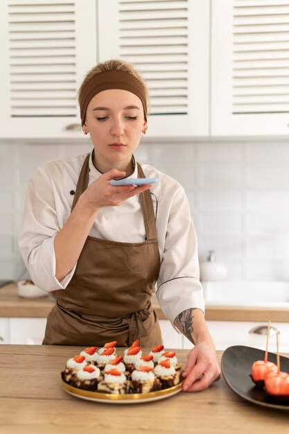 Woman taking photo of dessert medium shot