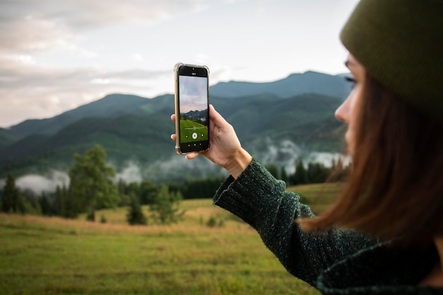 Woman taking a photo of the rural surroundings