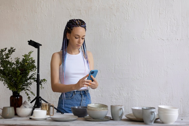 Woman taking photos for her business with kitchenware