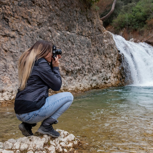 Free photo woman taking photos of nature