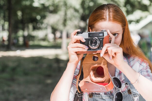 Woman taking picture with camera