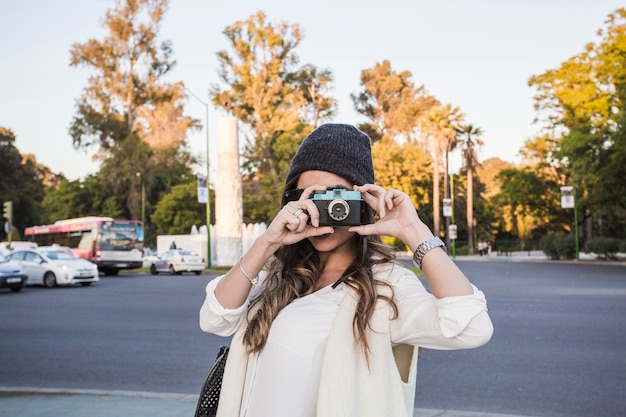 Woman taking pictures on street