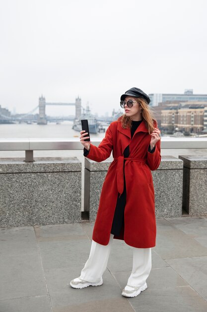 Free photo woman taking a selfie on a bridge