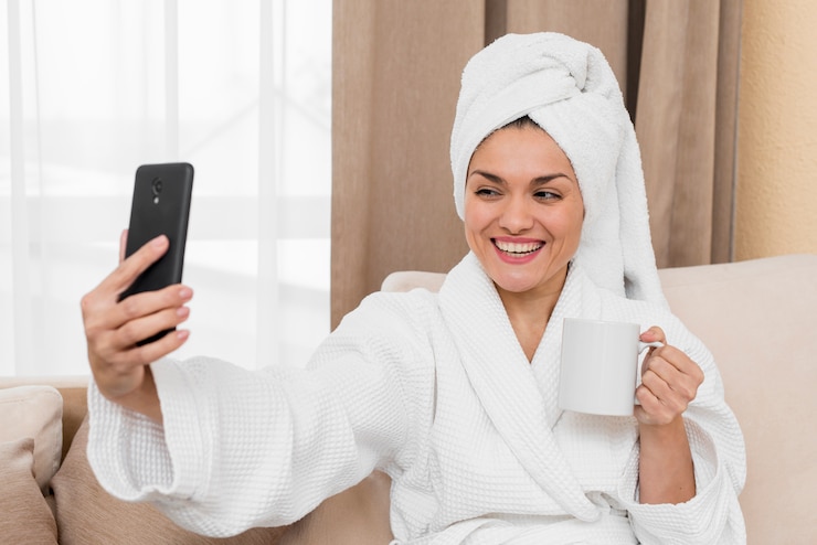 Free Photo woman taking selfie in hotel room