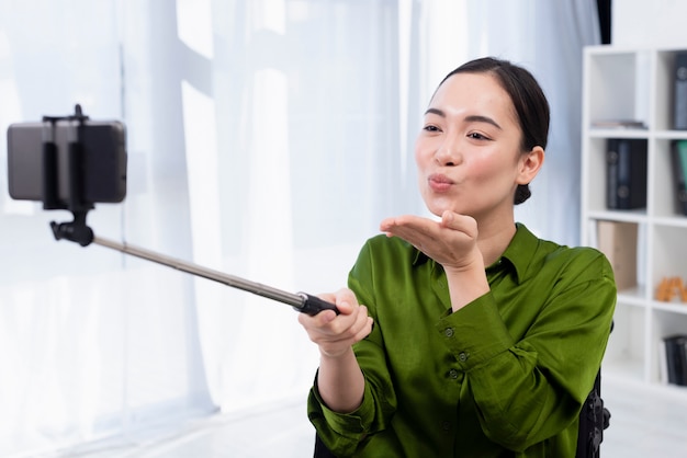 Woman taking selfie indoors