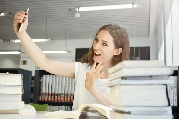 Woman taking selfie photo at office