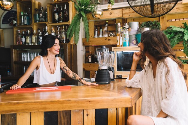 Woman talking to bartender