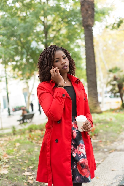 Woman talking by smartphone and looking