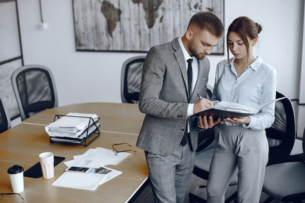 Woman talking to the director.Businessman signs documents.Colleagues work together