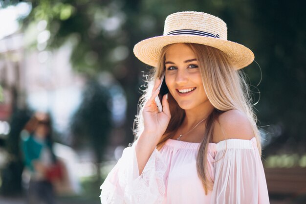 Woman talking on the phone otside the street