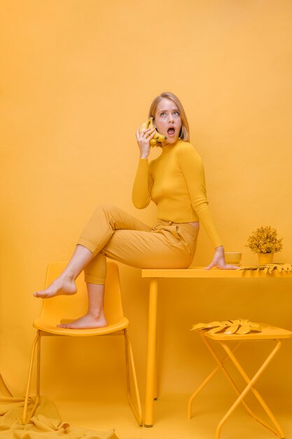 Woman talking on phone in a yellow scene