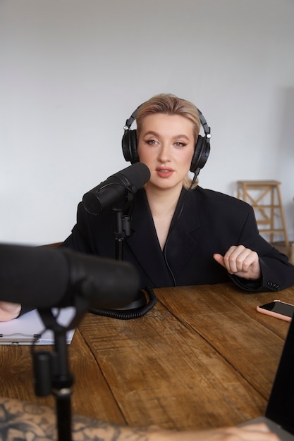 Free photo woman talking at podcast front view