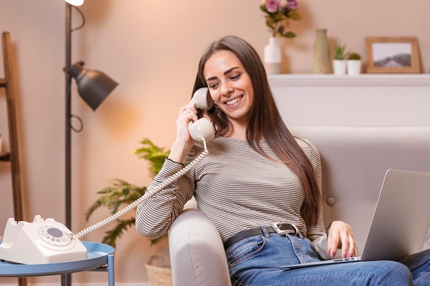 Woman talking at vintage telephone