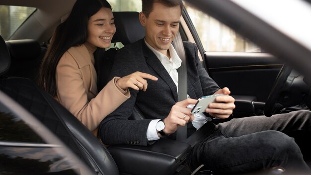 Woman talking with a taxi driver in the car