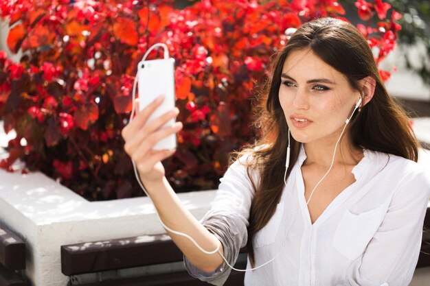 Woman talks via headphones on the phone