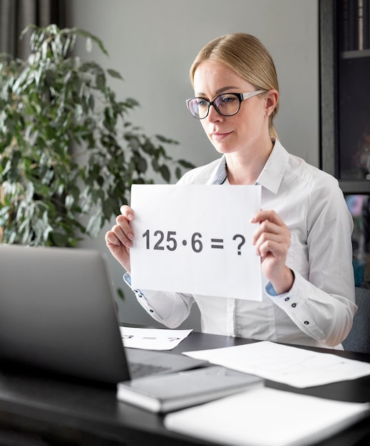 Woman teaching her students some multiplications