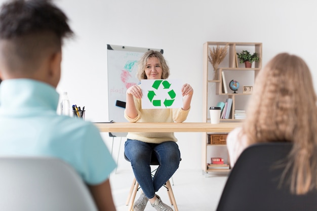 Woman teaching kids how to recycle