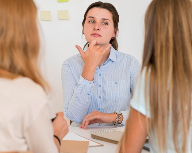 Woman teaching sign language to other people