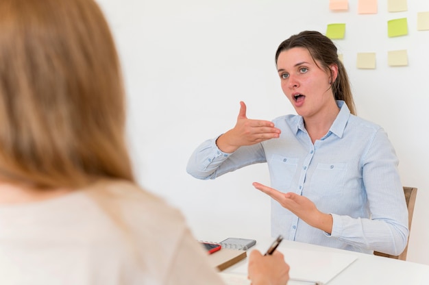 Woman teaching the sign language to someone else