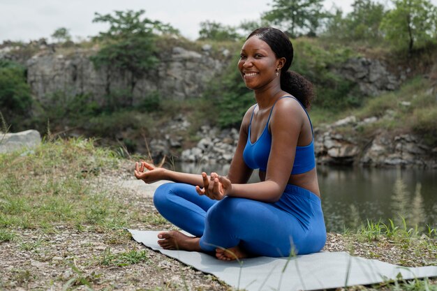 Woman teaching a yoga pose outdoors