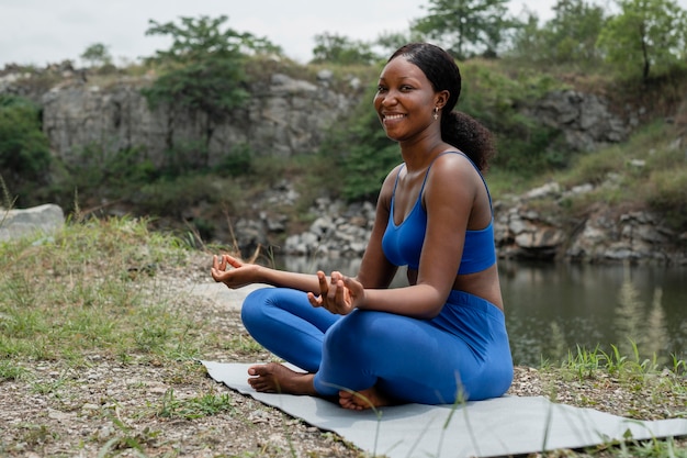 Woman teaching a yoga pose outdoors