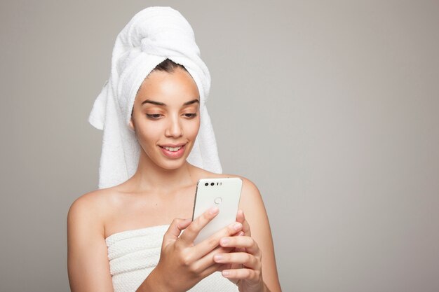 Woman texting with after bath