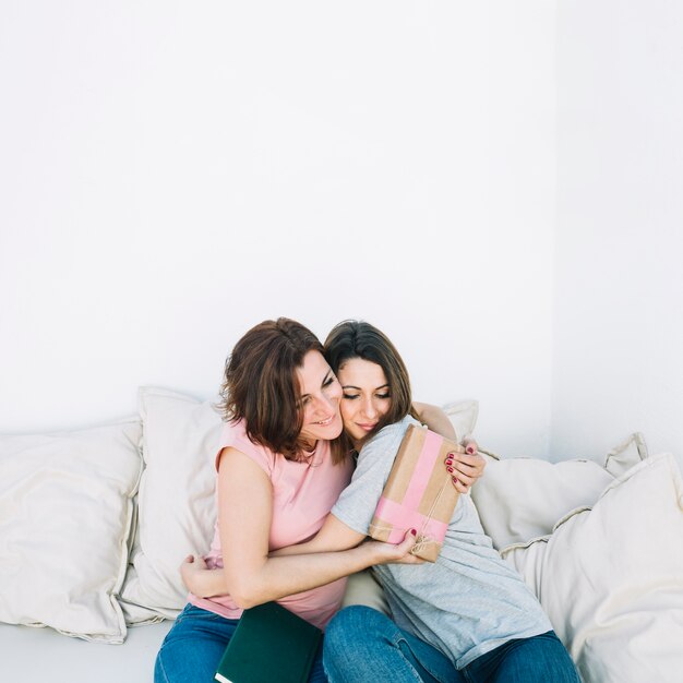 Woman thanking woman for gift at home