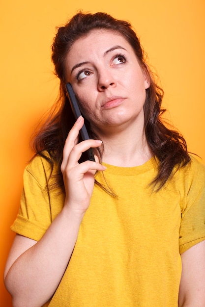 Free photo woman in thoughts having a phone call