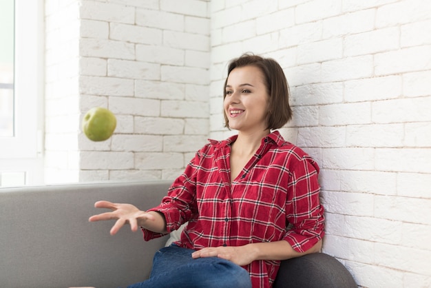 Free photo woman throwing apple