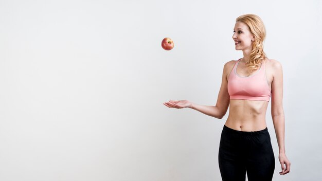 Free photo woman throwing an apple