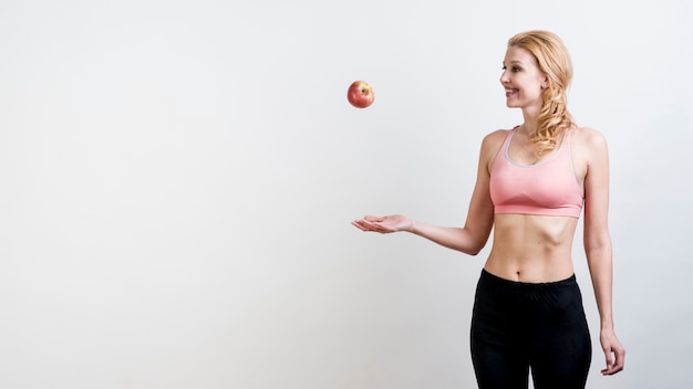Woman throwing an apple