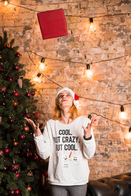 Woman throwing gift box in air