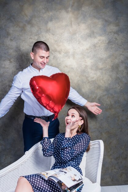 Free photo woman throwing up heart balloon