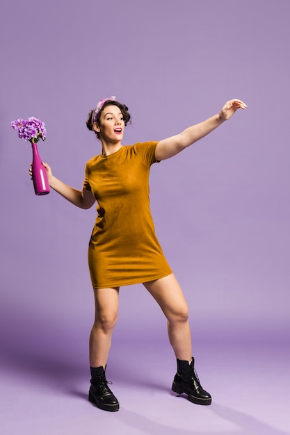 Woman throwing a vase with flowers