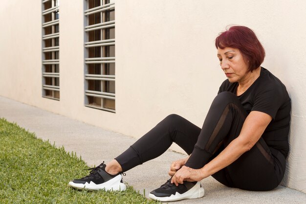 Woman ties the laces outdoors