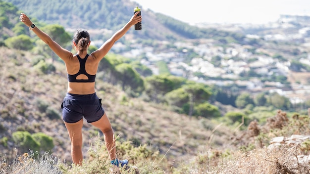 Woman on top of mountain