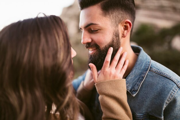Woman touching boyfriend hipster beard
